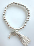 Beaded Silvery Bracelet With Dangling Wing And Tassel