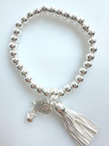 Beaded Silvery Bracelet With Dangling Wing And Tassel