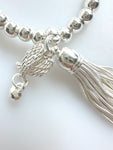 Beaded Silvery Bracelet With Dangling Wing And Tassel