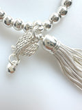 Beaded Silvery Bracelet With Dangling Wing And Tassel