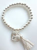 Beaded Silvery Bracelet With Dangling Wing And Tassel