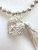 Beaded Silvery Bracelet With Dangling Wing And Tassel