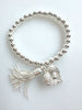 Beaded Silvery Bracelet With Dangling Wing And Tassel