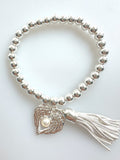 Beaded Silvery Bracelet With Dangling Wing And Tassel