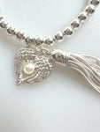 Beaded Silvery Bracelet With Dangling Wing And Tassel