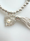 Beaded Silvery Bracelet With Dangling Wing And Tassel