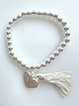 Beaded Silvery Bracelet With Dangling Wing And Tassel
