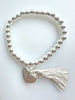 Beaded Silvery Bracelet With Dangling Wing And Tassel