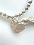 Beaded Silvery Bracelet With Dangling Wing And Tassel