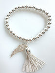 Beaded Silvery Bracelet With Dangling Wing And Tassel