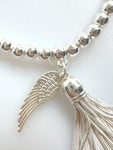 Beaded Silvery Bracelet With Dangling Wing And Tassel