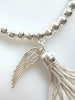 Beaded Silvery Bracelet With Dangling Wing And Tassel