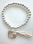 Beaded Silvery Bracelet With Dangling Wing And Tassel