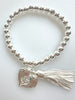 Beaded Silvery Bracelet With Dangling Wing And Tassel