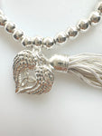 Beaded Silvery Bracelet With Dangling Wing And Tassel