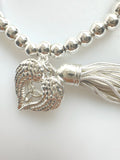 Beaded Silvery Bracelet With Dangling Wing And Tassel