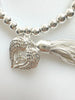 Beaded Silvery Bracelet With Dangling Wing And Tassel